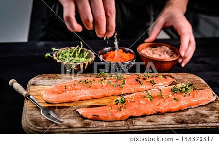 Girl Salting Fresh Red Trout Fish With Species 138370312