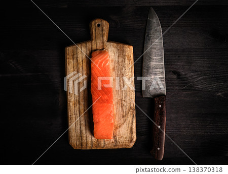 fillet of raw salmon red fish on a cutting board with a big kitc fillet of raw salmon red fish on a cutting board with a big kitc 138370318