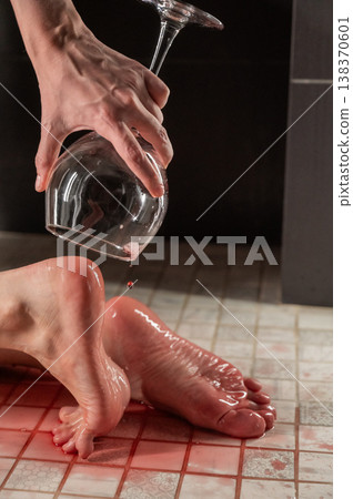 Foot fetish. A woman pours wine from a glass onto her feet in the shower. Foot fetish. A woman pours wine from a glass onto her feet in the shower. 138370601