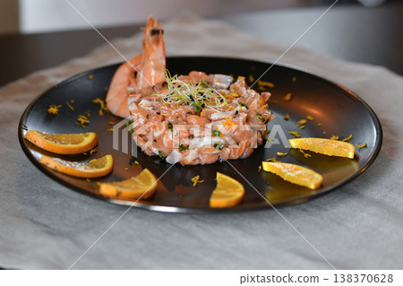 Fresh salmon tartare with shrimp citrus garnish gourmet seafood plate 138370628