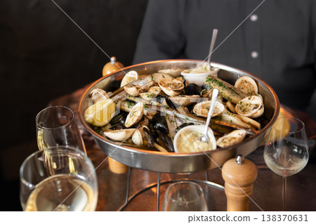 Elegant seafood platter with shellfish served on table with wine 138370631