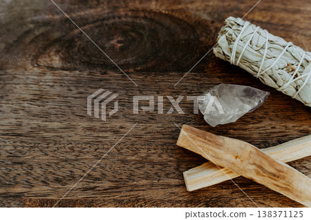 Palo santo sticks, white sage bundle and clear quartz crystal on wooden background Palo santo sticks, white sage bundle and clear quartz crystal on wooden background 138371125