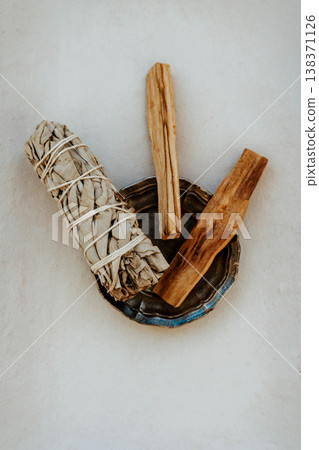 White sage bundle and palo santo sticks in metal dish on white background White sage bundle and palo santo sticks in metal dish on white background 138371126