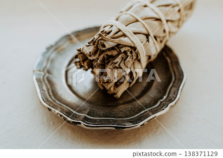 Close up of white sage bundle in ceramic dish on light background, Close up of white sage bundle in ceramic dish on light background, 138371129