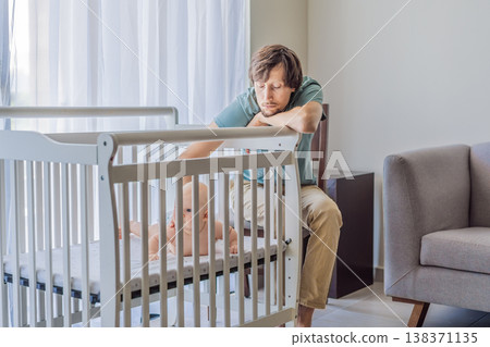Tired father sitting by baby crib at home watching sleeping infant. Exhausted dad caring for newborn at night. Parenting fatigue, childcare responsibility, love and real family life concept Tired father sitting by baby crib at home watching sleeping infant. Exhausted dad caring for newborn at night. Parenting fatigue, childcare responsibility, love and real family life concept 138371135