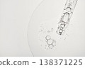 Dropper releasing clear liquid with bubbles, highlighting serum texture and purity 138371225