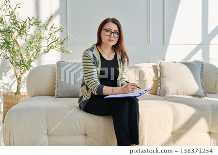 Portrait of professional psychologist therapist woman with clipboard in office Portrait of professional psychologist therapist woman with clipboard in office 138371234
