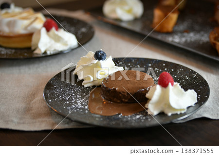 Melting chocolate cake pudding on a plate Melting chocolate cake pudding on a plate 138371555