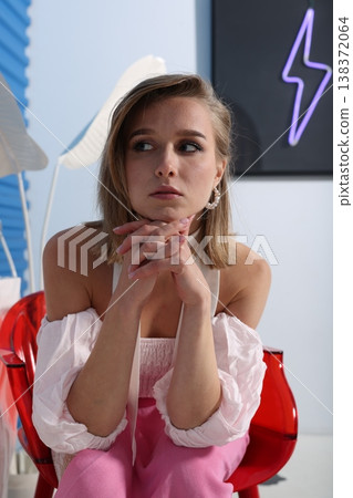 Girl with pink attire reacts with expressive face before camera 138372064