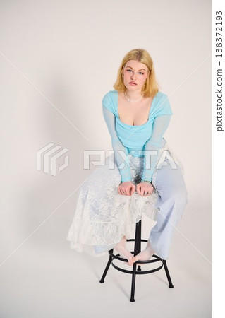 Charming blonde female sitting gracefully in oldfashioned setting 138372193