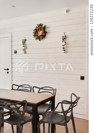 Charming rustic dining area with wreath and mood lighting Charming rustic dining area with wreath and mood lighting 138372236