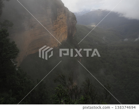 Red cliffs shrouded in mist – overlooking the deep forests of the Blue Mountains. Red cliffs shrouded in mist – overlooking the deep forests of the Blue Mountains. 138374694