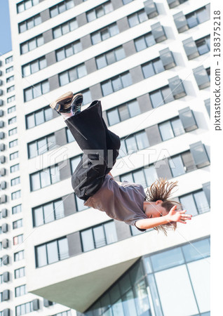 A girl jumps on an outdoor trampoline. A girl jumps on an outdoor trampoline. 138375218