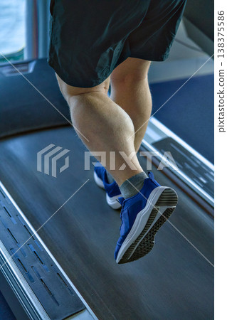 Intense Gym Session With Focused Calf Muscles Moving Rhythmically On Treadmill Intense Gym Session With Focused Calf Muscles Moving Rhythmically On Treadmill 138375586