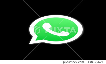 The iconic WhatsApp logo featuring a green speech bubble with a white telephone symbol, set against a stark black background. Represents global communication and instant messaging. 138375621