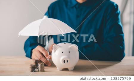 bank piggy money protect financial insurance concept risk umbrella collage finance represented by person holding white umbrella over ceramic piggy bank and stacks of silver coins bank piggy money protect financial insurance concept risk umbrella collage finance represented by person holding white umbrella over ceramic piggy bank and stacks of silver coins 138375799