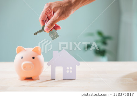 Ensuring cyber bank piggy security for saving, Privacy measures are crucial, hand presents house key over house model, illustrating diligent financial planning for future property investment, Ensuring cyber bank piggy security for saving, Privacy measures are crucial, hand presents house key over house model, illustrating diligent financial planning for future property investment, 138375817