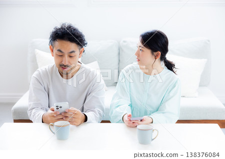 A couple looking at a smartphone 138376084