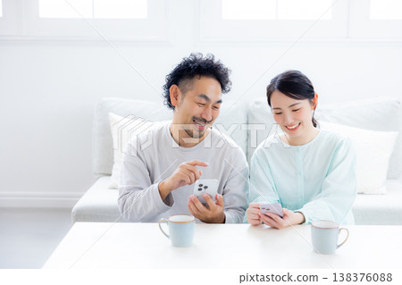A couple looking at a smartphone 138376088