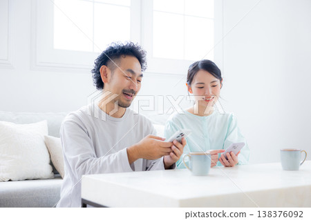 A couple looking at a smartphone A couple looking at a smartphone 138376092