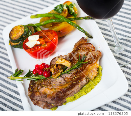 Fried beef loin with avocado puree and vegetables Fried beef loin with avocado puree and vegetables 138376205