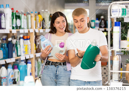 Couple man and woman choosing detergent in store Couple man and woman choosing detergent in store 138376215