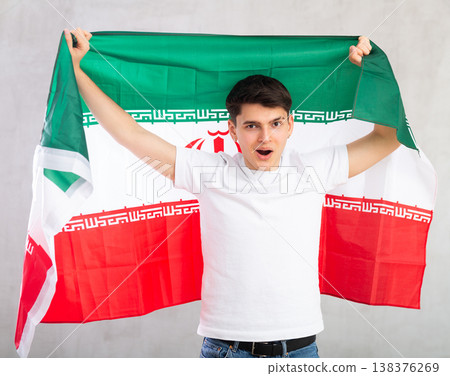 Surprised young guy holding Iran flag 138376269