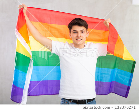 Portrait of guy holding an LGBT flag in hands 138376271