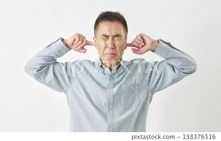 A man covering his ears on a white background A man covering his ears on a white background 138376516