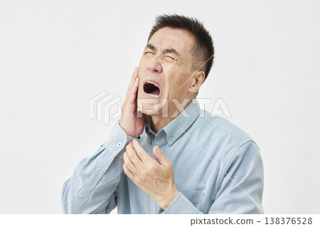 Man with toothache on white background Man with toothache on white background 138376528