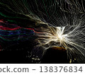 Abstract long exposure of colorful LED light trails and radiating white light patterns against a dark night background. Artistic light painting with vibrant lines creating a sense of motion. 138376834