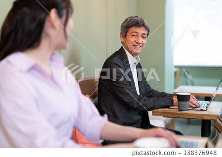Senior men and women having a meeting at a coworking space. 138376948