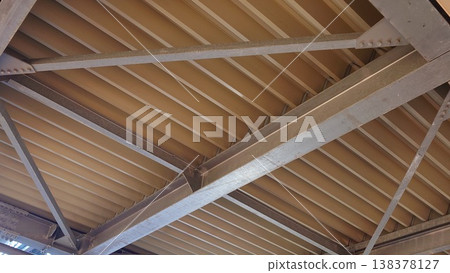 A view of the building's roof from below 138378127