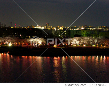 Night view of Kawagoe City and cherry blossoms in full bloom at Isanuma Lake, Kawagoe City, Saitama Prefecture (aerial photography by drone) Night view of Kawagoe City and cherry blossoms in full bloom at Isanuma Lake, Kawagoe City, Saitama Prefecture (aerial photography by drone) 138378362