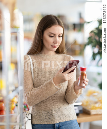 Young woman scanning qr code for ground pepper 138378432