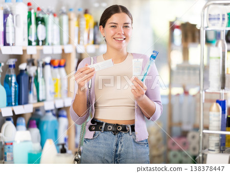 Young woman choosing toothbrush in department store 138378447