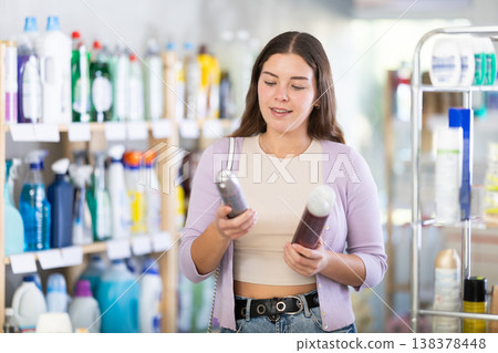Young woman choosing hairspray in store Young woman choosing hairspray in store 138378448