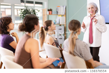 Senior woman coach speaks to audience of listeners, carry out lecture. 138378554