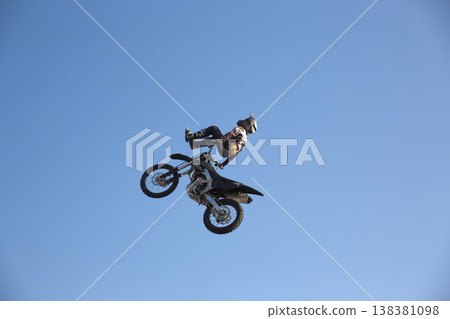 Motorcycle rider performing dangerous midair stunt trick Motorcycle rider performing dangerous midair stunt trick 138381098