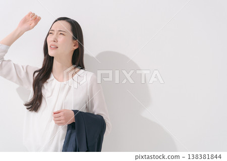 Image of a woman working in a suit during the hot summer. 138381844
