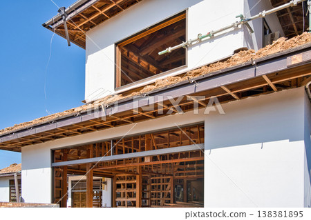 Demolition site of an old wooden house; roof covered with earth. Demolition site of an old wooden house; roof covered with earth. 138381895
