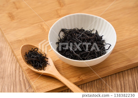 Dried hijiki seaweed, a Japanese food ingredient served in a small white bowl. Dried hijiki seaweed, a Japanese food ingredient served in a small white bowl. 138382230