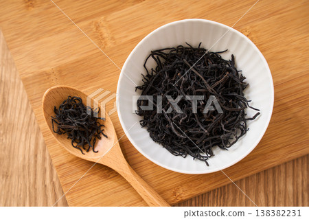 Dried hijiki seaweed, a Japanese food ingredient served in a small white bowl. Dried hijiki seaweed, a Japanese food ingredient served in a small white bowl. 138382231