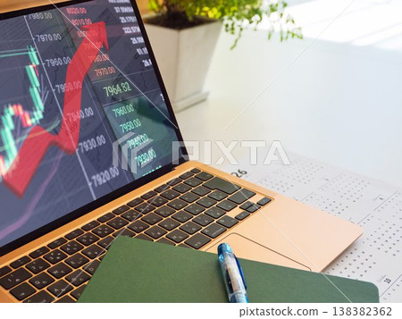 Analytical PC screen showing rising stock prices 138382362