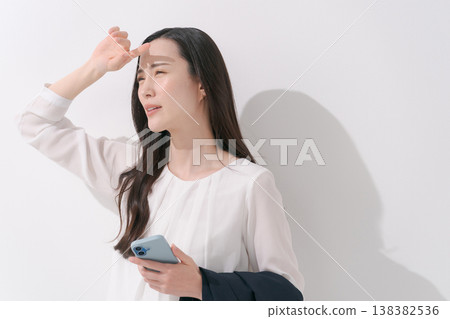 Image of a woman working in a suit during the hot summer. Image of a woman working in a suit during the hot summer. 138382536