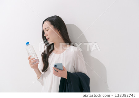 Image of a woman working in a suit during the hot summer. 138382745