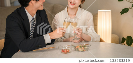 A man and woman, a married couple, or a couple toasting with champagne sparkling wine. A man and woman, a married couple, or a couple toasting with champagne sparkling wine. 138383219