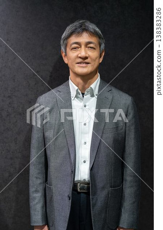 A portrait of a smiling middle-aged Japanese businessman. A portrait of a smiling middle-aged Japanese businessman. 138383286