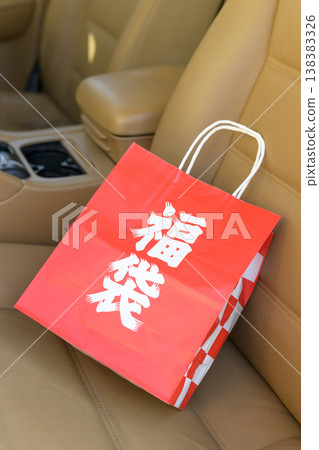 A lucky bag placed on the seat of a luxury car A lucky bag placed on the seat of a luxury car 138383326
