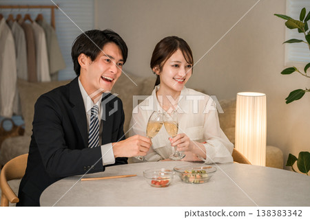 A man and woman, a married couple, or a couple toasting with champagne sparkling wine. A man and woman, a married couple, or a couple toasting with champagne sparkling wine. 138383342